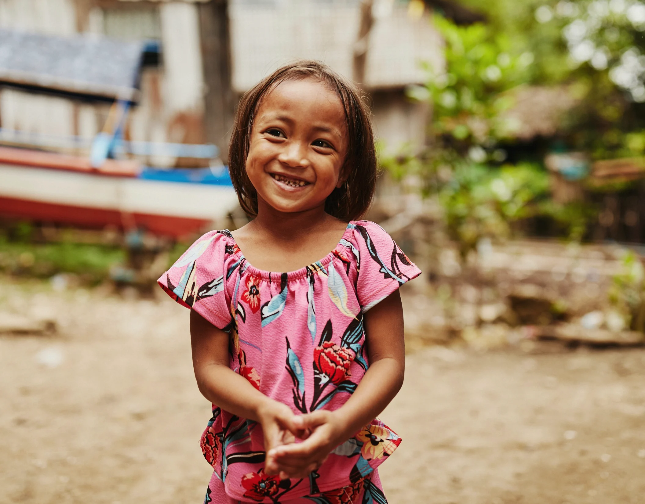 Photo of a group of students in green uniforms, smiling and laughing