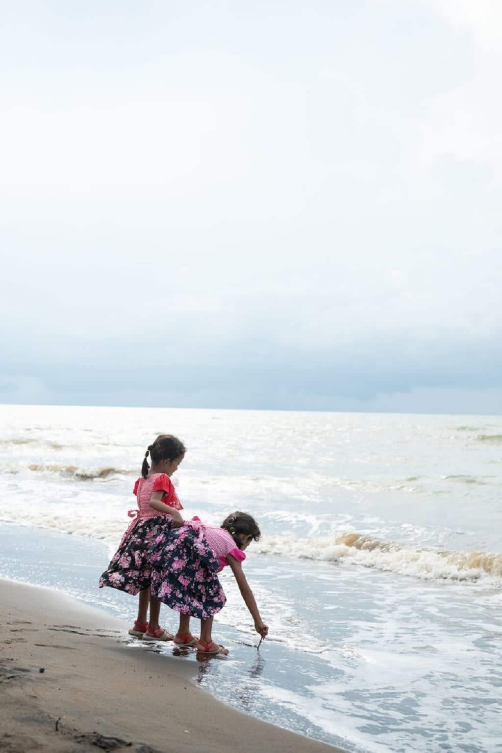 Two girls playing by the beach