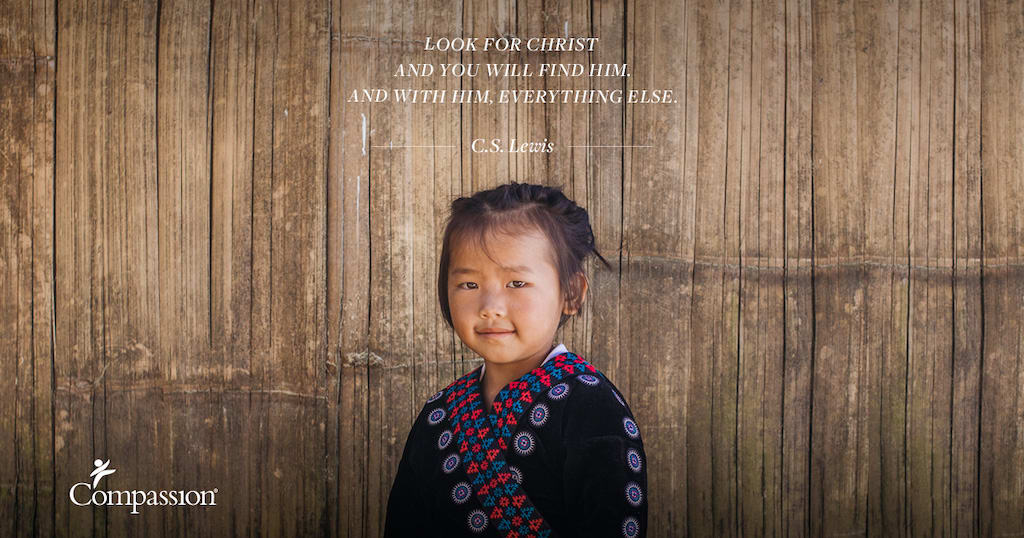 A young Thai girl in traditional clothing stands against a wooden wall. Quote on image says: “Look for Christ and you will find Him. And with Him, everything else.” – C.S. Lewis