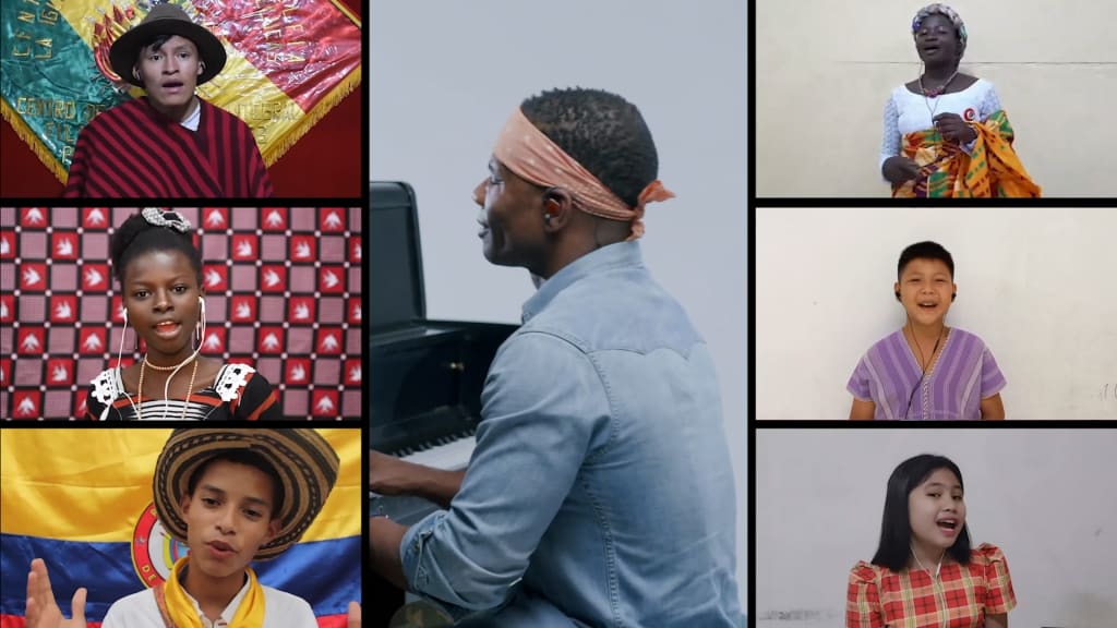 Thumbnail of the Lean on Me music video. Kirk Franklin is in the middle playing piano, surrounded by images of youth from around the world singing.