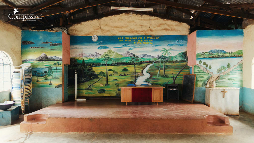 The front of a church sanctuary with a mural.