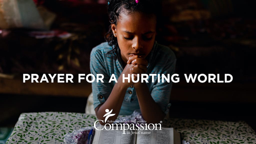 Cover graphic for the "Prayer for a Hurting World" devotional, which includes the title, Compassion's logo and an image of an Ethiopian girl praying with a Bible open on the table in front of her.