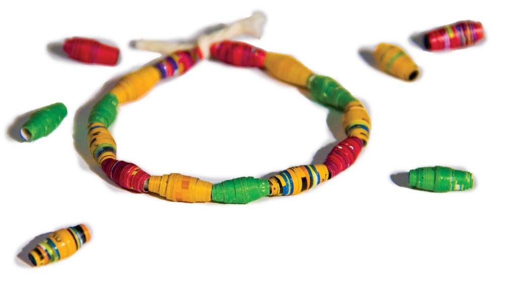 A close-up picture of a handmade bracelet made of paper beads.