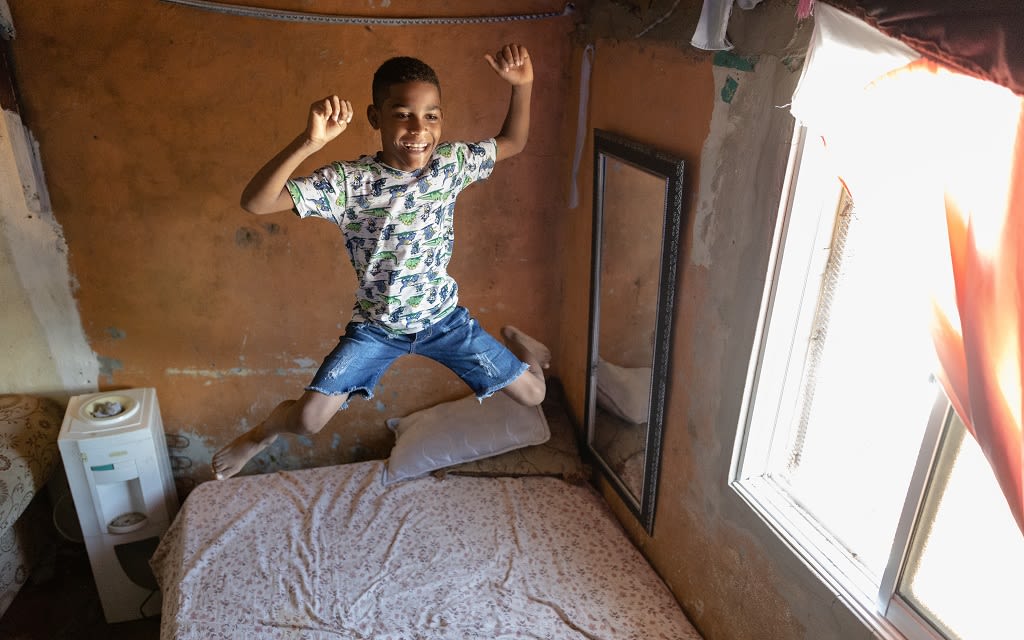 Boy jumping on the bed