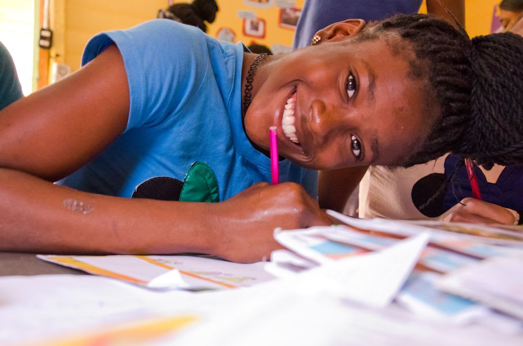 Arisleisy happily responds to a letter from her sponsor at her child development centre in the Dominican Republic.