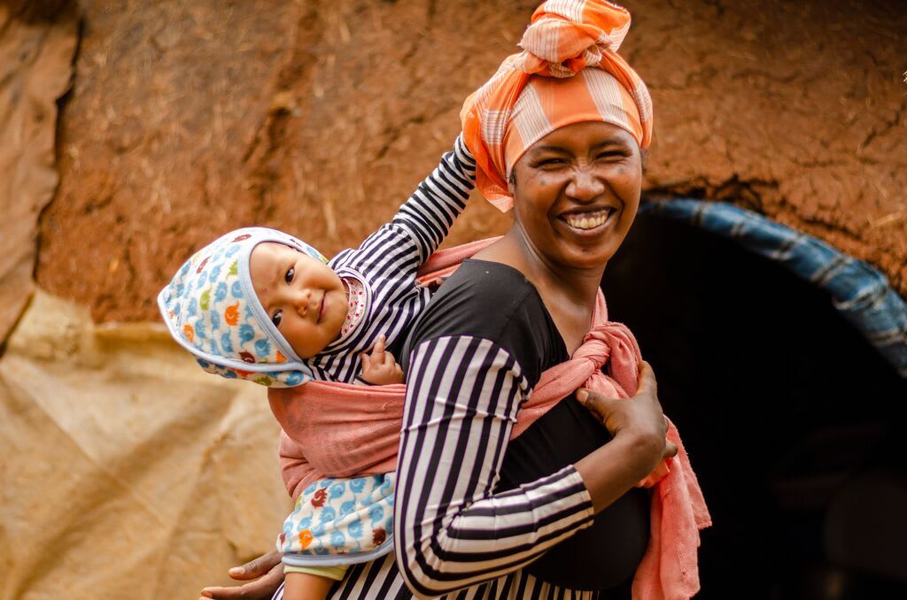 In Ethiopia, a mom carries her baby on her back using a cloth.
