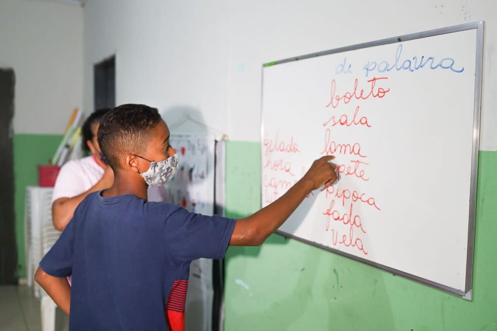 Boy reading from a whiteboard