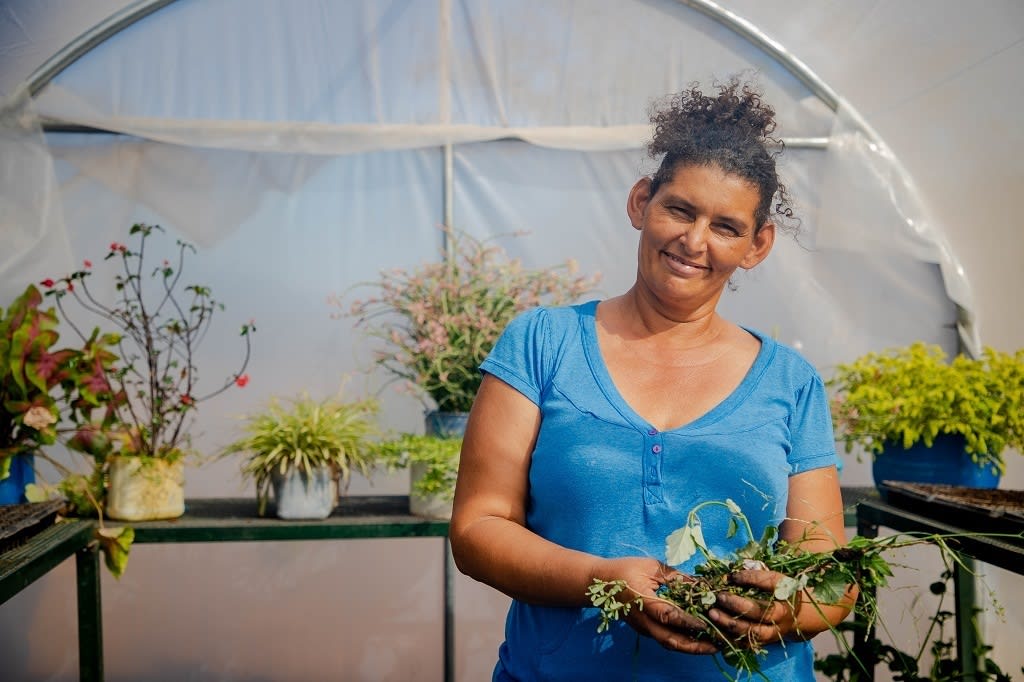 Woman holding vegetables. In times of food insecurity, the gift of vegetable seeds makes a huge difference.