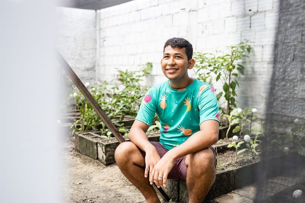 Young man sitting in a small garden