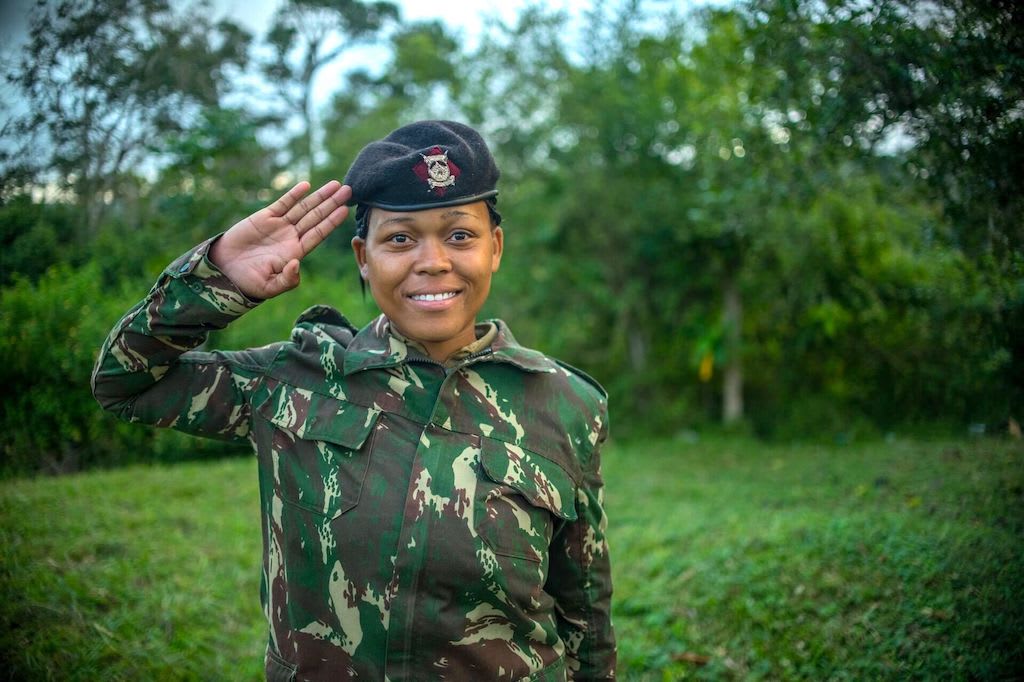 Miriam in her police uniform, performing a salute.