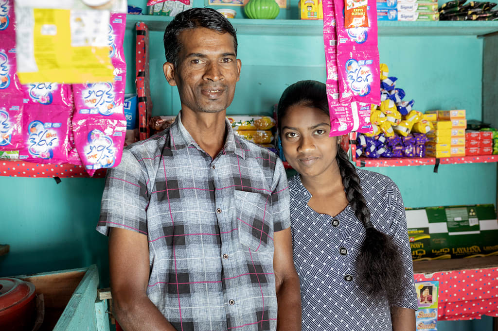 a man and a girl, his daughter, in a small shop
