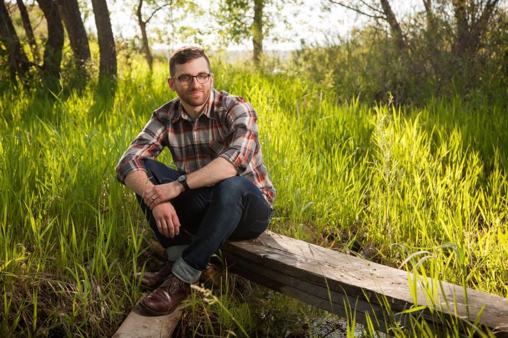 Dave sits on a wooden bench