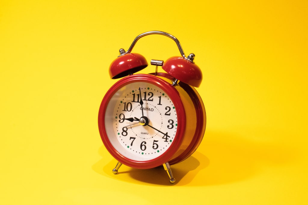 A red clock with a yellow background