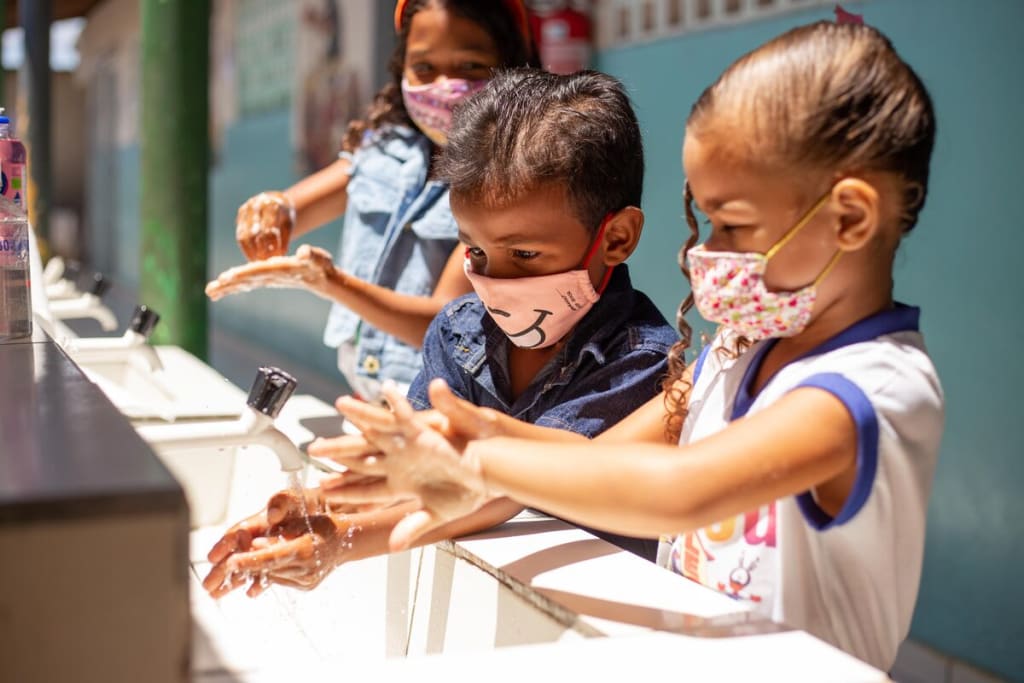 Compassion children washing hands during pandemic