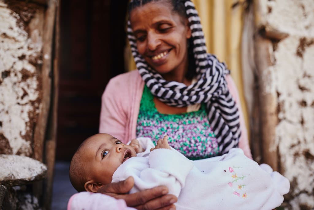 A woman cradles her baby.