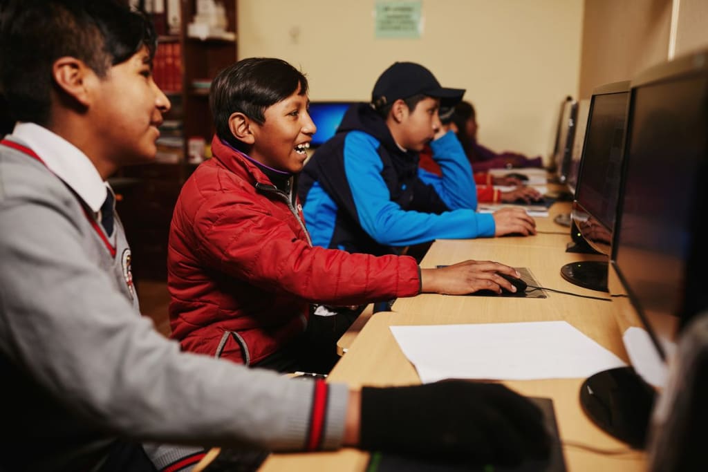 These kids in Compassion’s program are learning at their child development centre's new computer lab in Bolivia.