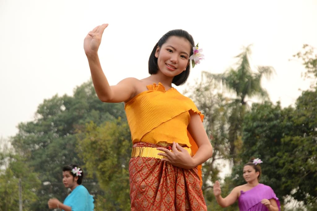 A young woman doing a traditional dance in Thailand.