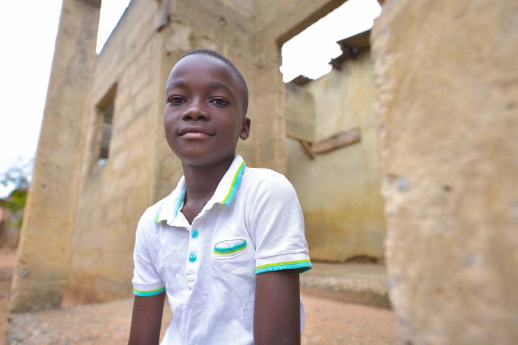 A portrait of Raphael, a 10-year-old boy in Ghana.