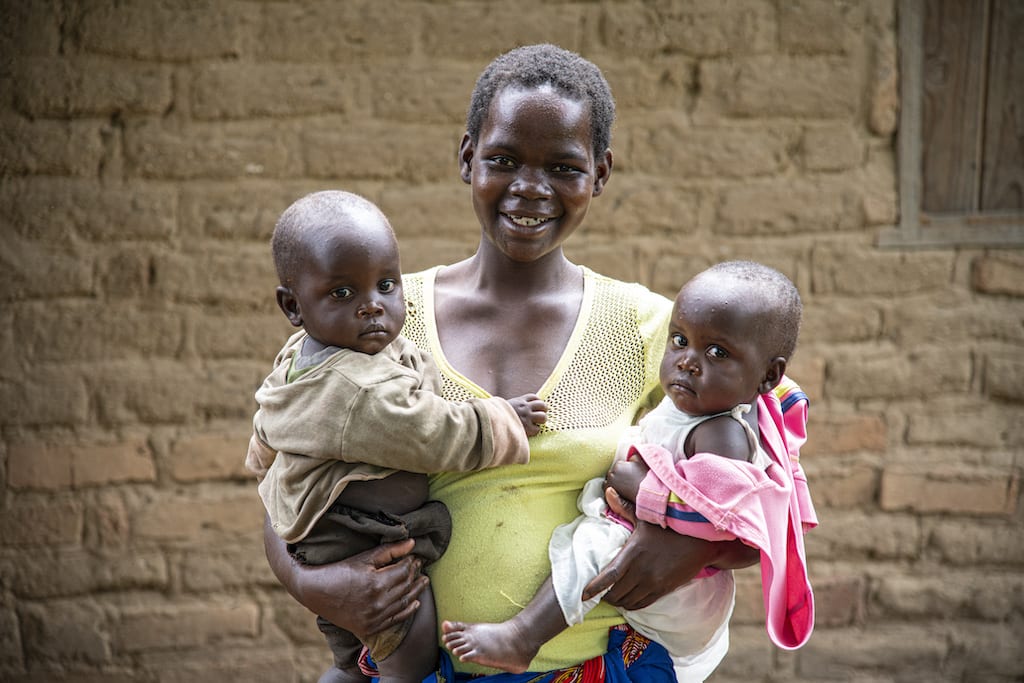 On Compassion registration day in Malawi, a mother holds her twin babies in her arms.