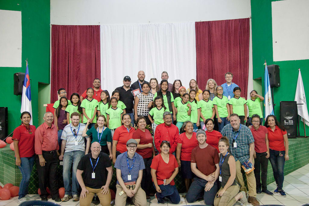 A group of Canadian pastors and Compassion staff with Guatemalan staff and children at a Compassion centre at a local church.
