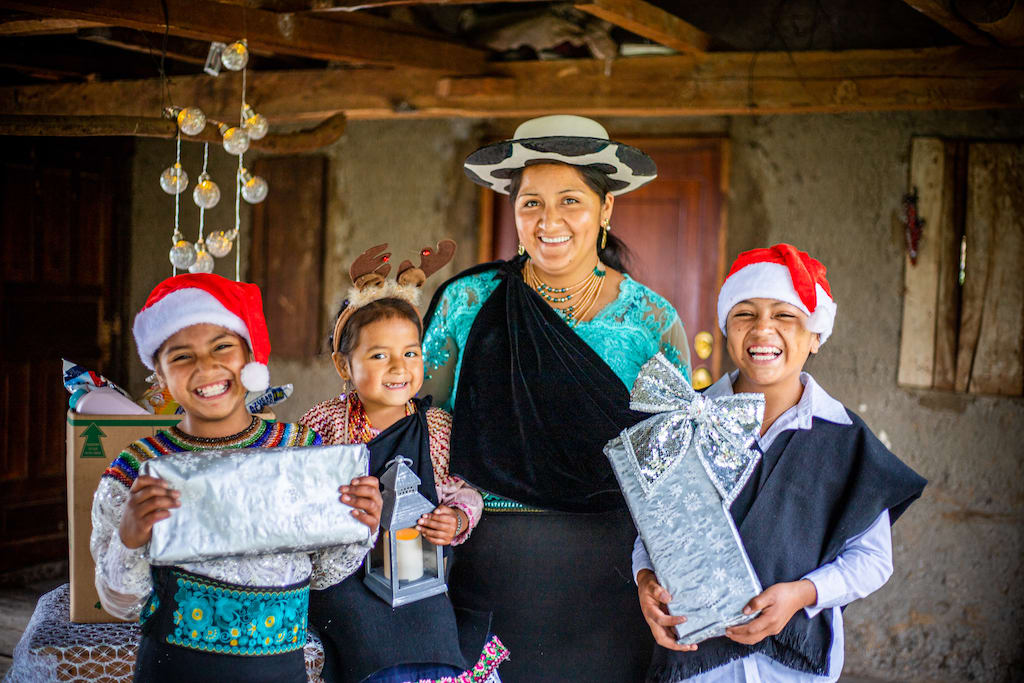 Jenny and all her children are filled with joy and excitement after a special Christmas delivery from their Compassion centre