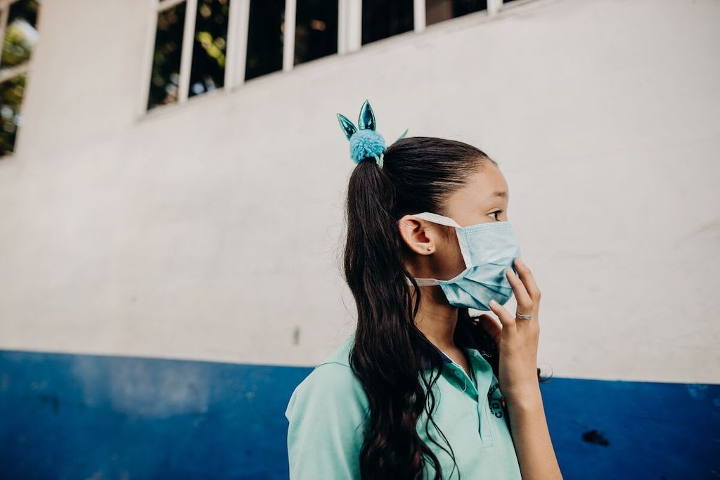 A girl wearing a protective face mask