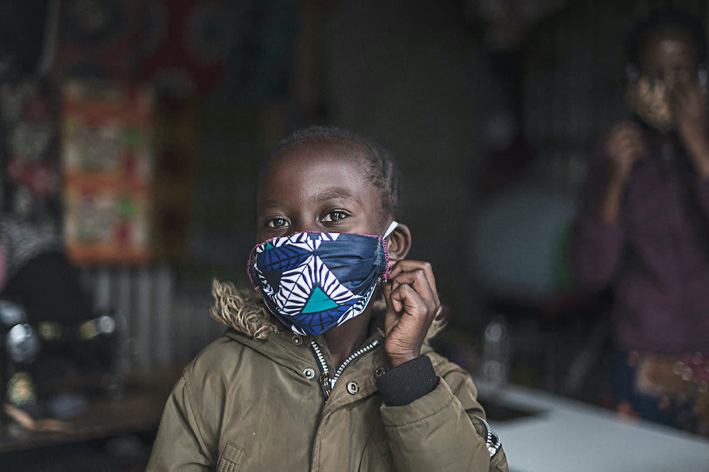 A child wearing a cloth protective face mask
