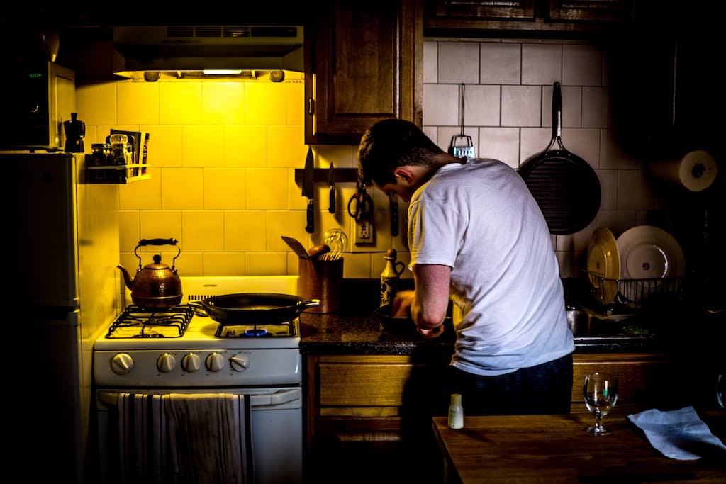 A man cooking in his kitchen.