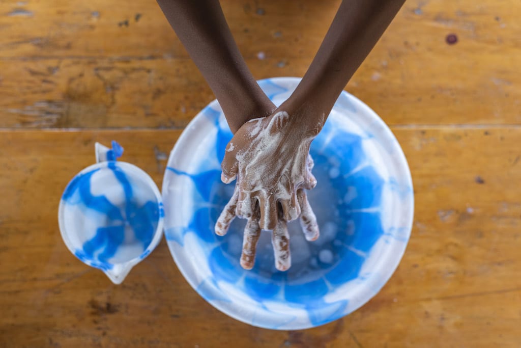 A pair of hands being washed.