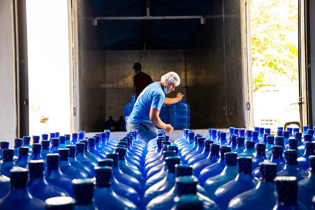 Joel loads a truck with water for delivery to Compassion Centres in the region.