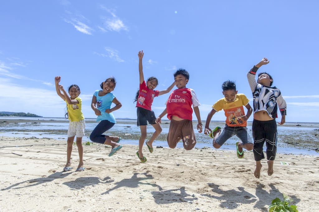 A group of children jumping.