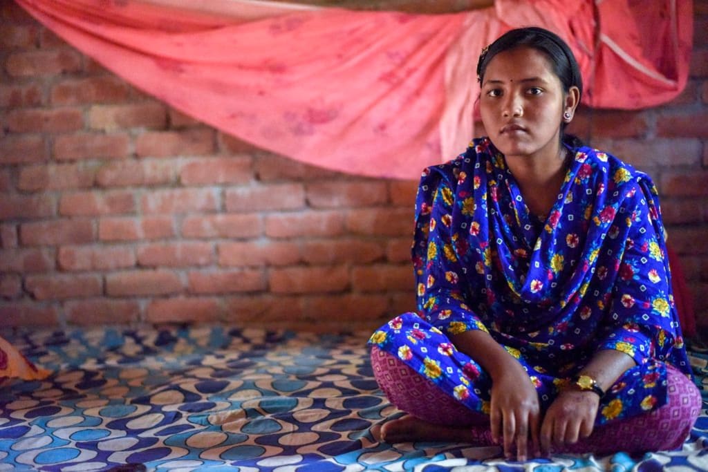 Ratna sits in her bedroom at her home in rural Bangladesh.
