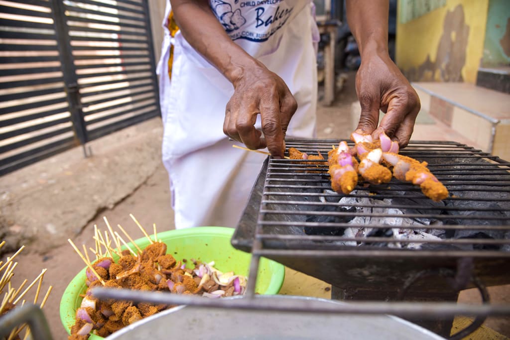 hands making kebabs on a grill