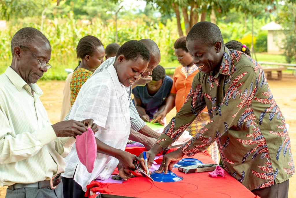 Community members make reusable sanitary pads together.