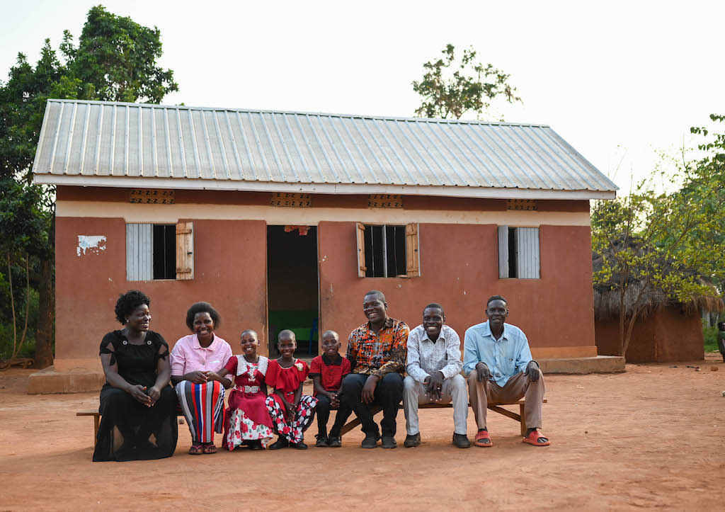 Annet and the triplets with the staff of the Compassion centre in front of the home built for them with the help of Compassion supporters.