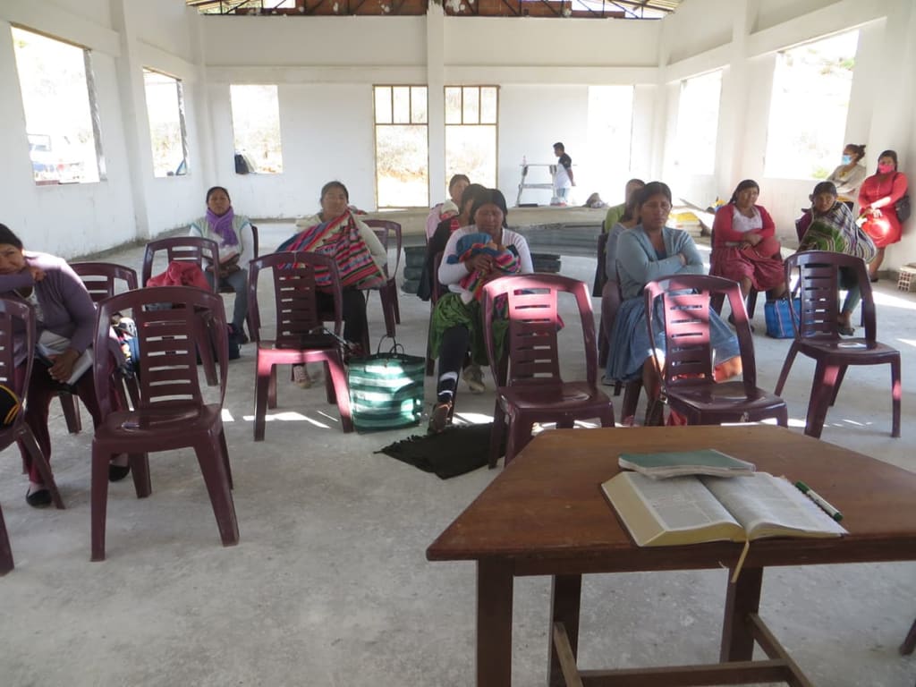 children and parents sit and listen to sunday school.