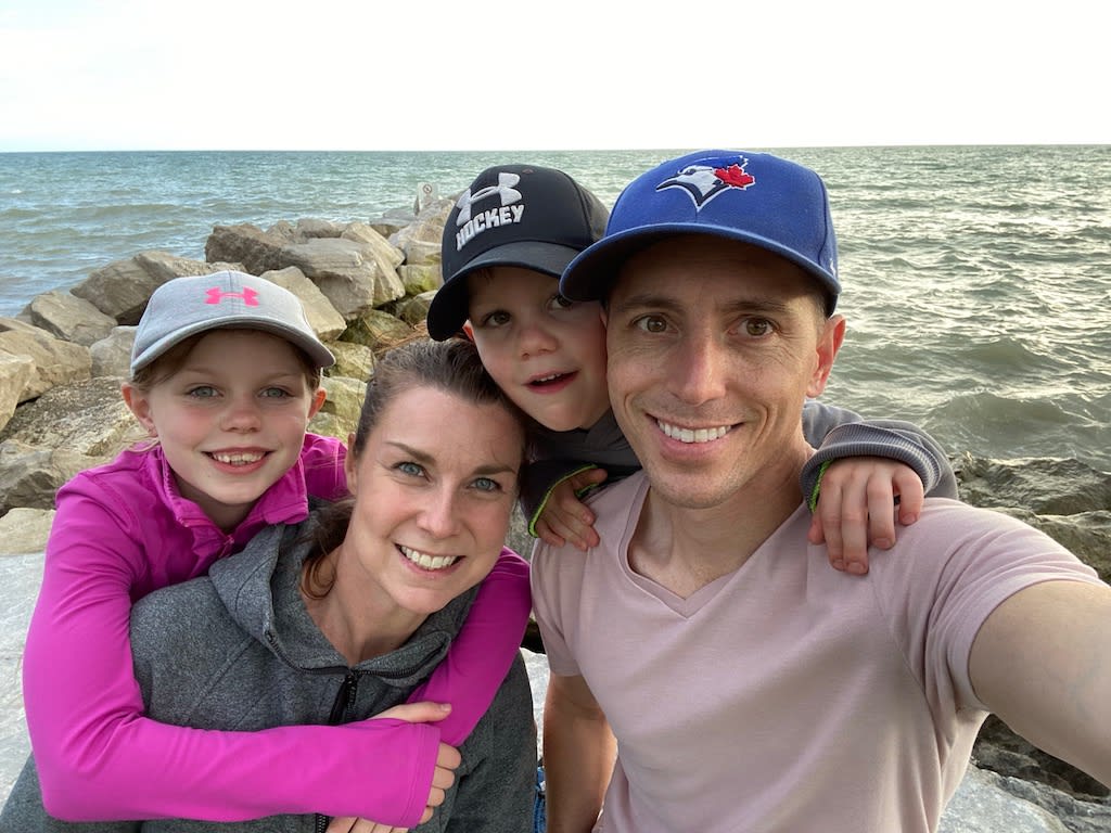 John with his wife and two kids at the beach.