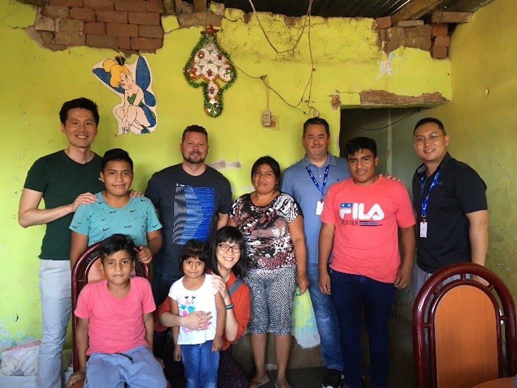A group of Canadian pastors with a Peruvian family in their home.