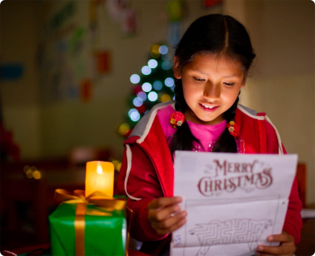 Nery reads a Christmas letter from her sponsor