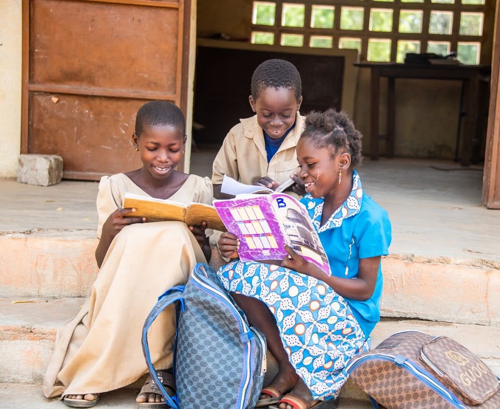 Children reading outside their classroom