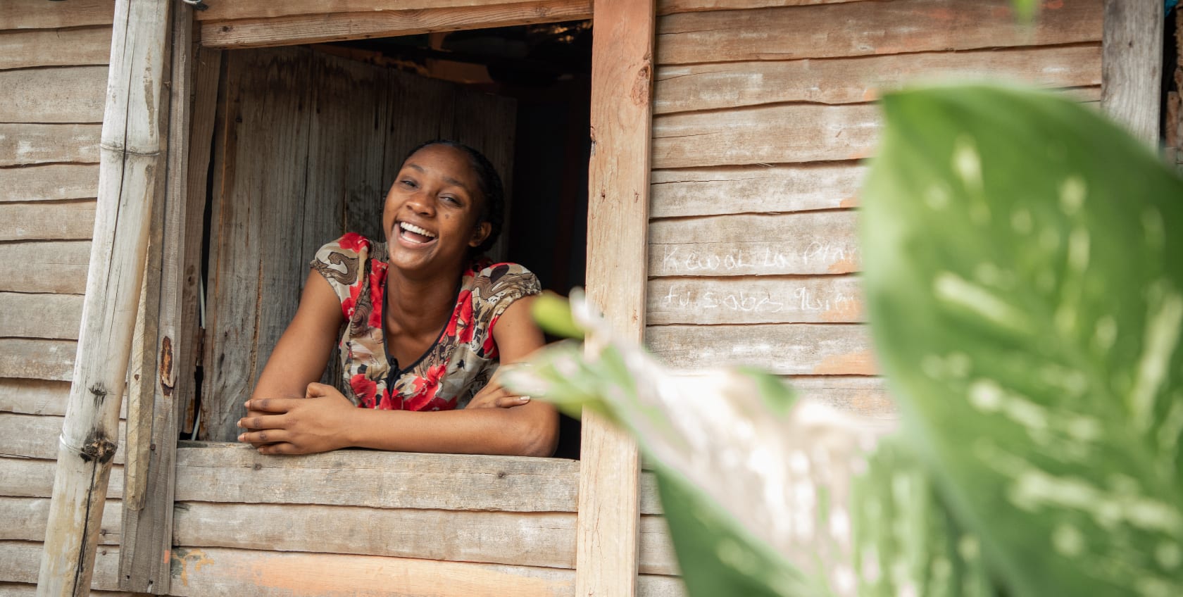 Girl leaning on the window smiling