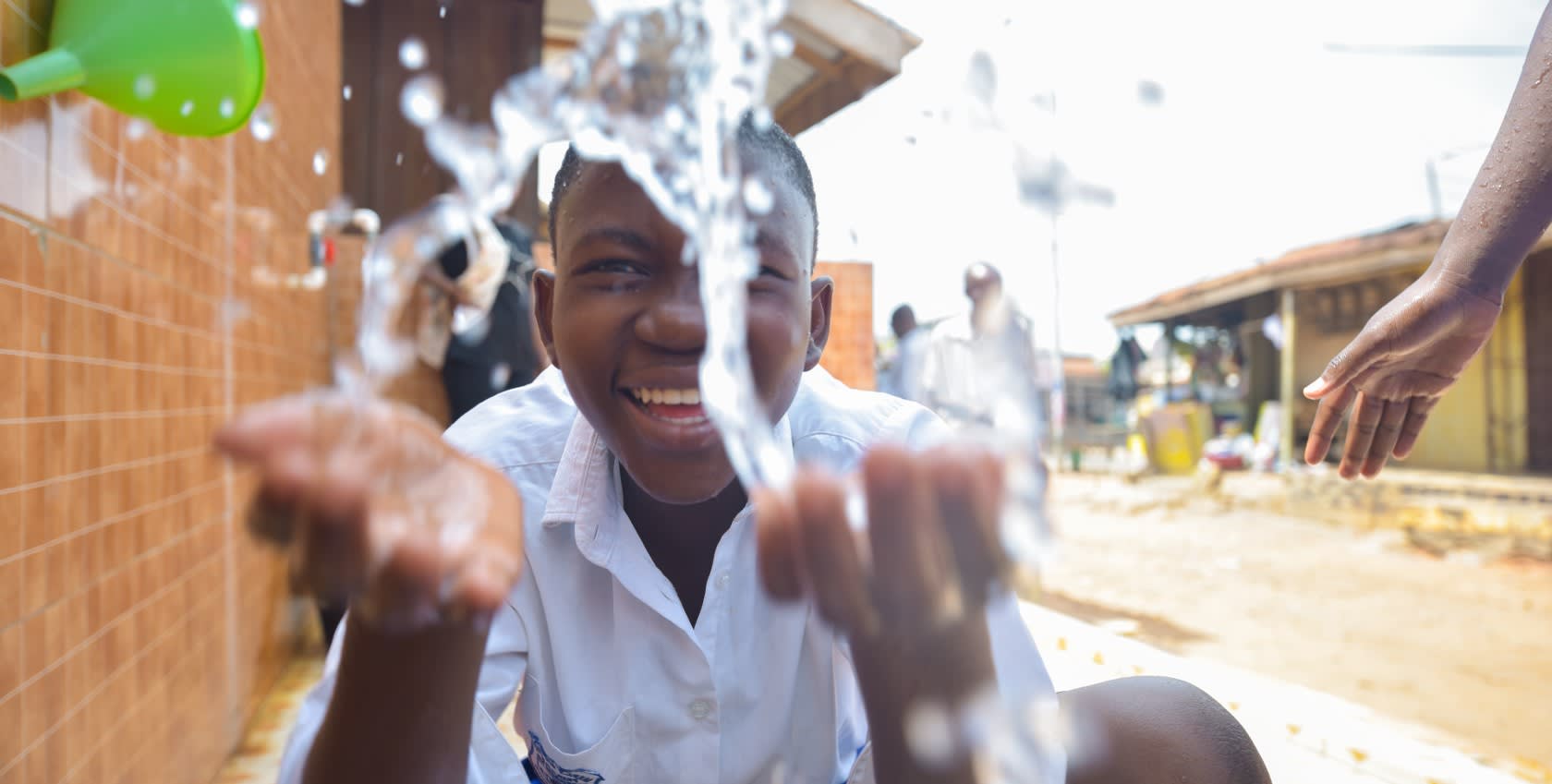 A child washing his hand with clean water