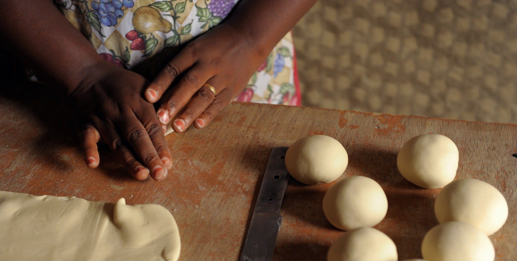 A woman's hand making bread dough