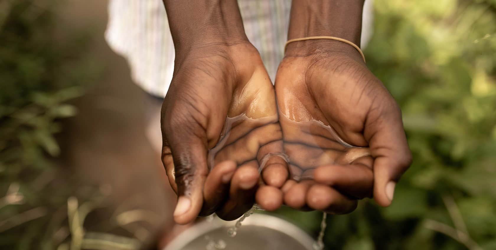 A lady's hand holding clean water