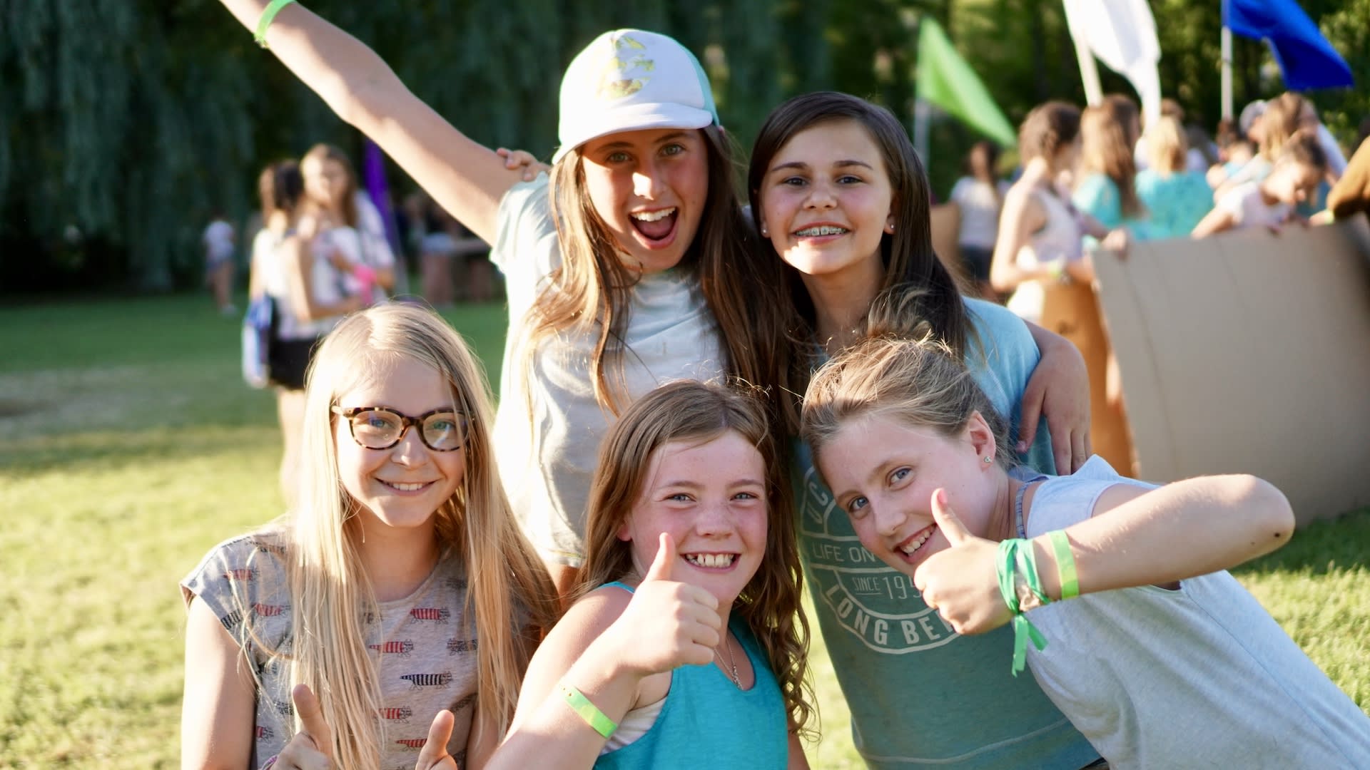 A group of five girls pose together at camp.