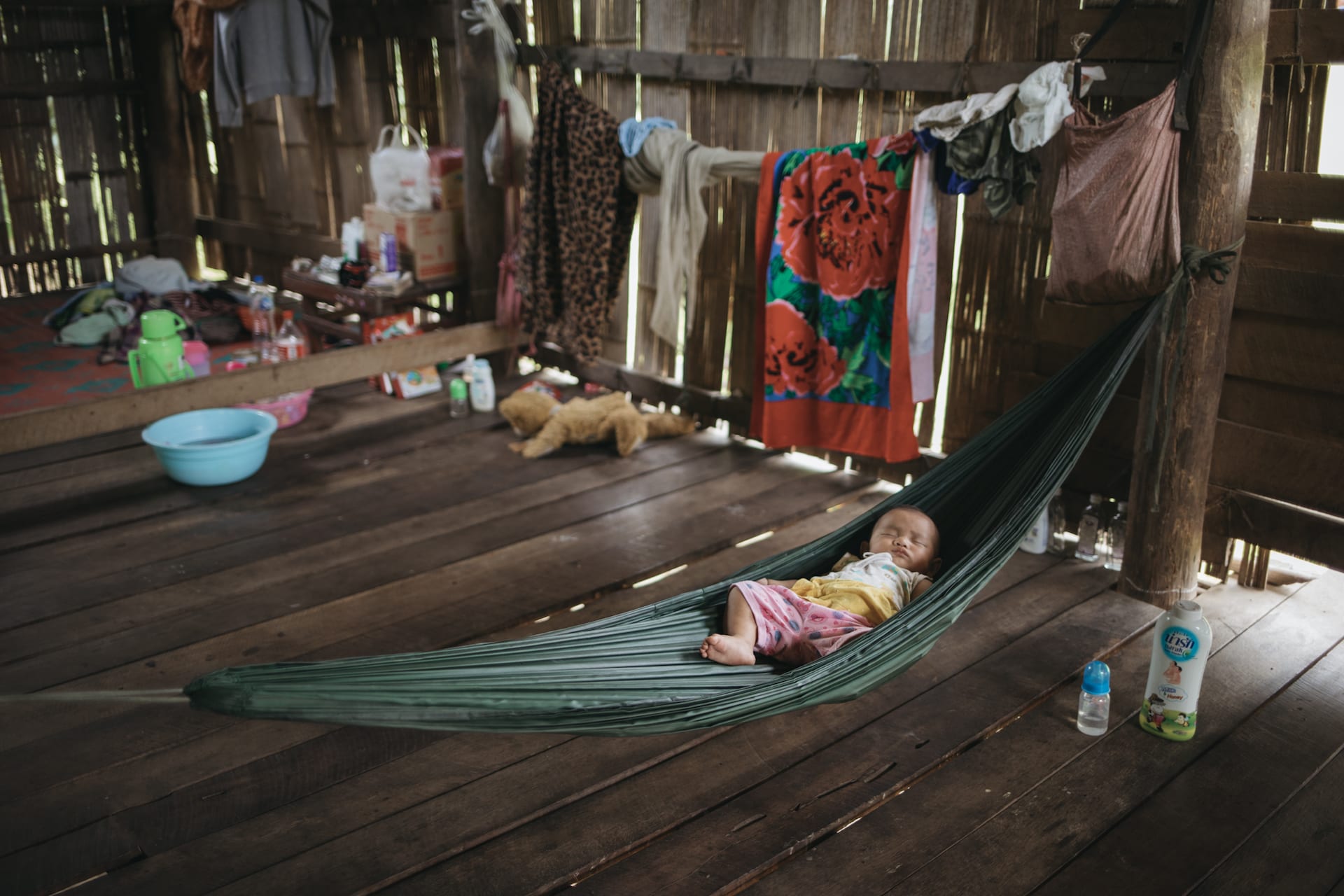 Baby Sathinee in a hammock in her home.