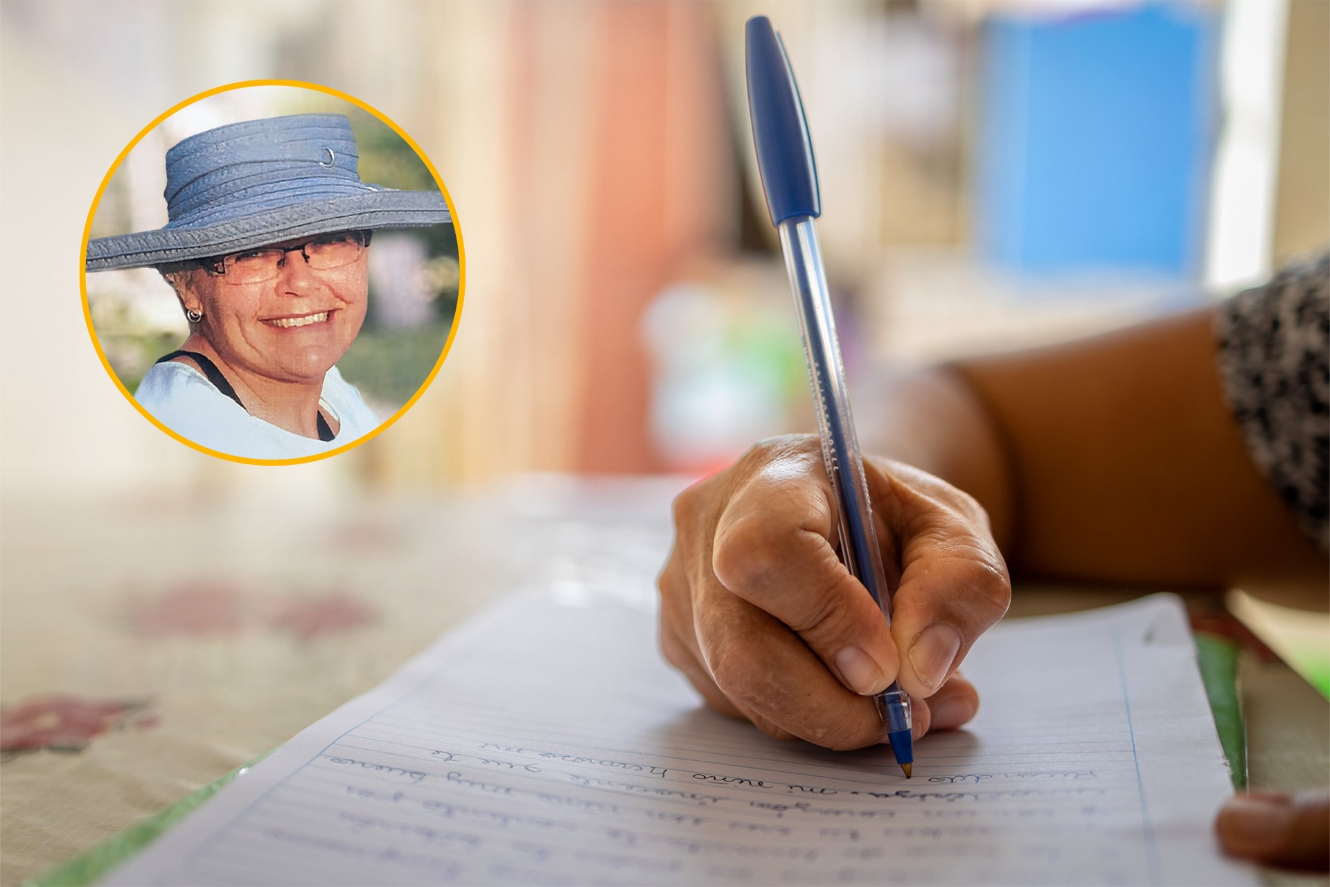 A picture of a woman writing on paper with a pen. There is a circle photo of Gail in the corner wearing a blue hat.