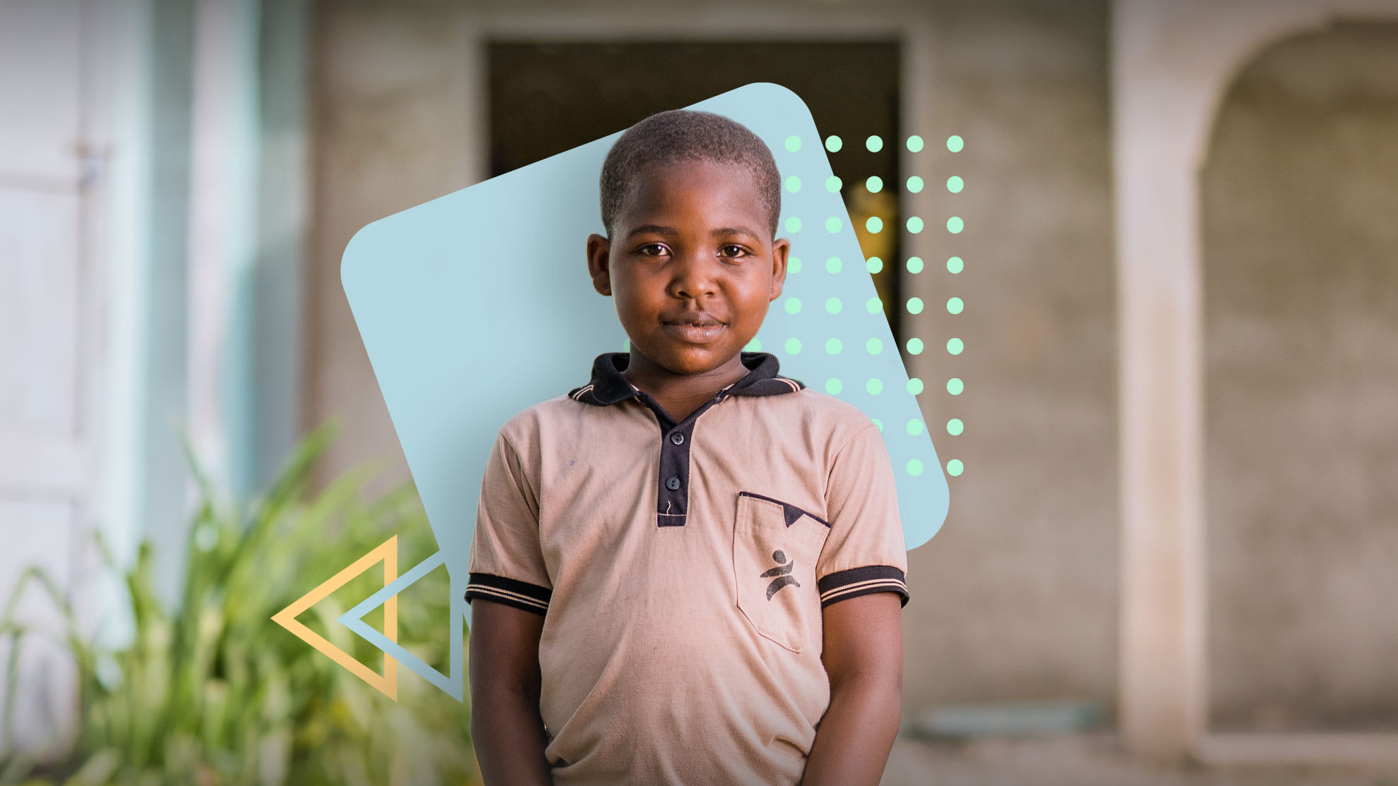 A Black child stands wearing a pink shirt with a dark collar and a Compassion logo on the chest.