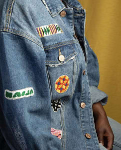 A girl sitting in a jean jacket