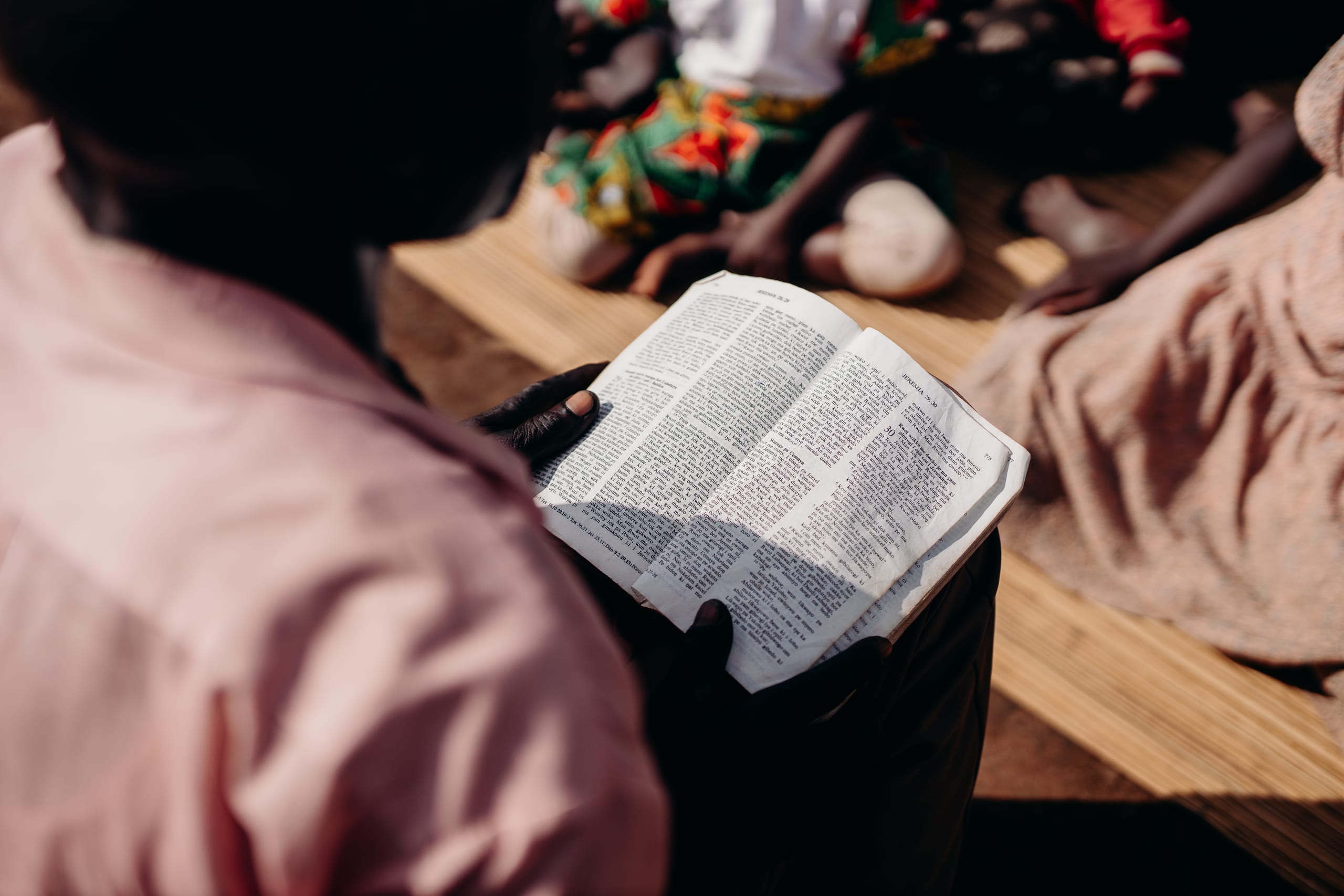 A teenager in Uganda reading the Bible.